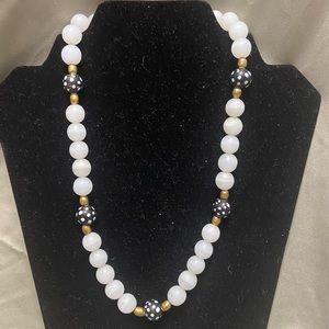 White stones, brass, and black & white dot beads make this a unique necklace